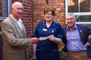 Mike and Norman present a cheque for Â£1,000 to Caroline Gilleece, Matron of RUH Oncology Department 